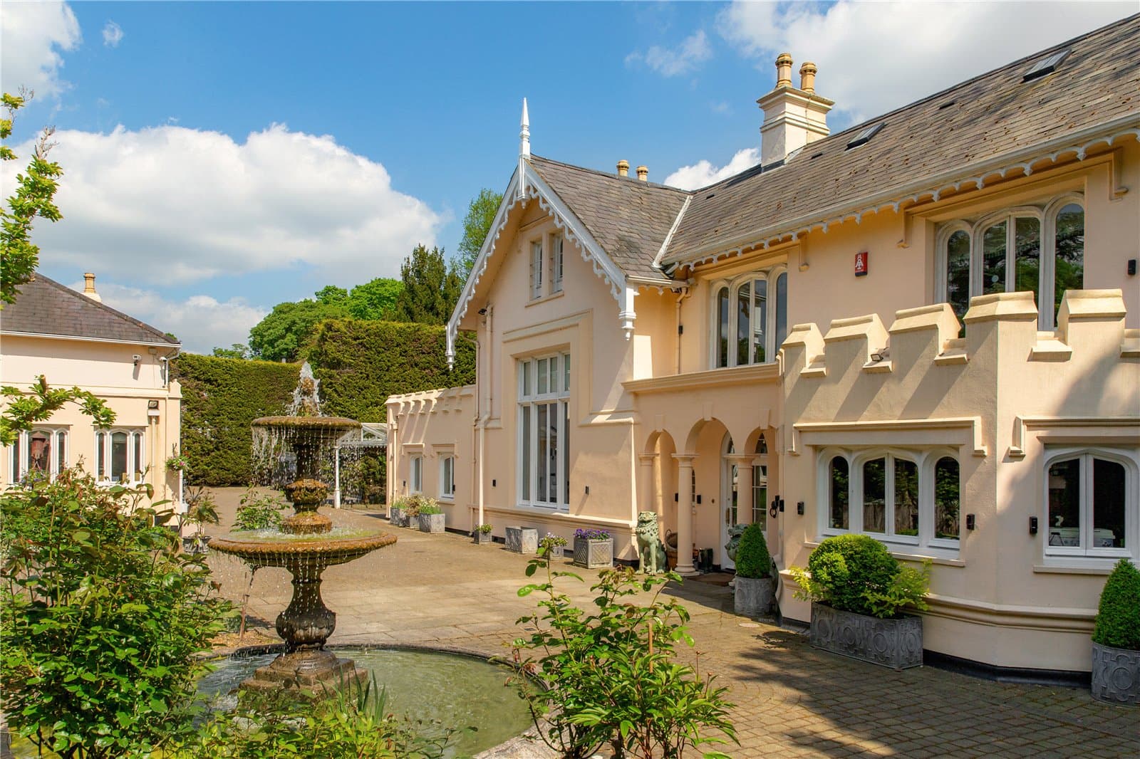 Exterior courtyard and fountain at Highwood Lodge, Highwood Hill, London with period architecture and landscaped planting